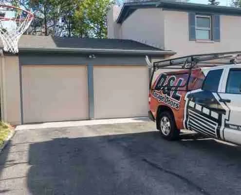 Old beige garage doors before replacement