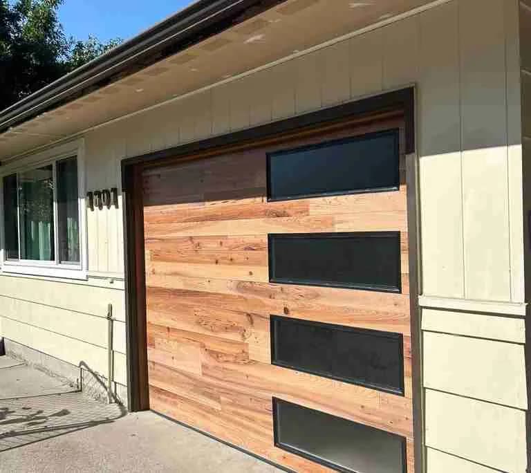 Modern plank door with wood and black panel accents