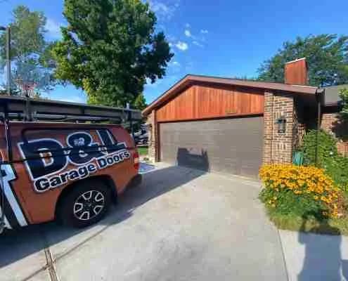 Old tan garage door before replacement